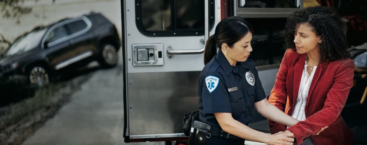 An EMT personnel attending to a public safety worker during a road mishap