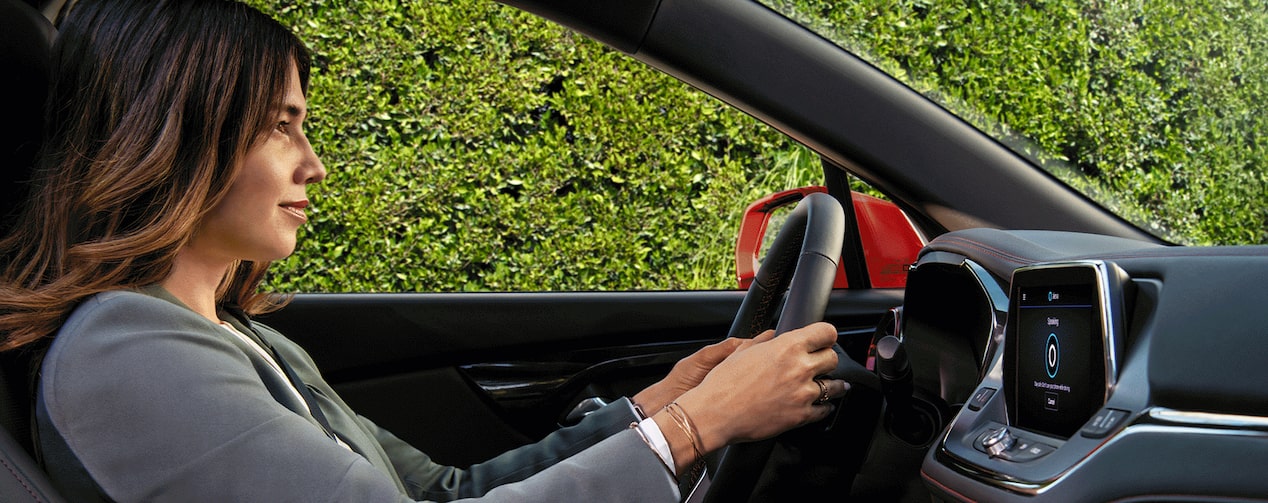 A person using the OnStar Alexa built-in feature while driving a vehicle.