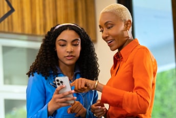 Woman using OnStar app to share the control of the vehicle with Family Members.