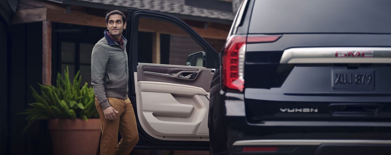 Man entering a GMC vehicle.