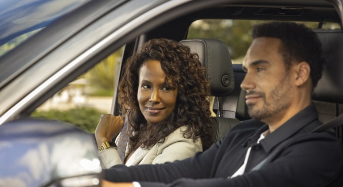 Woman in Passenger Seat Smiling at Man Driving